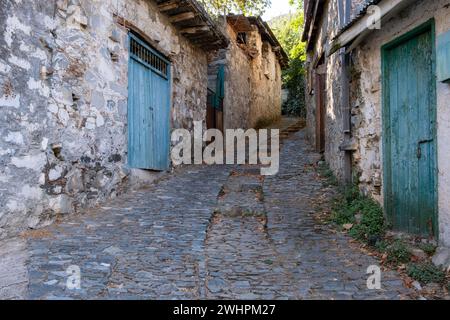 Stoned footpath crossing a traditional village. Stoned houses with wooden doors. Vintage architecture Stock Photo