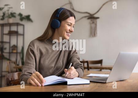 Happy adult student woman studying on Internet, using laptop Stock Photo