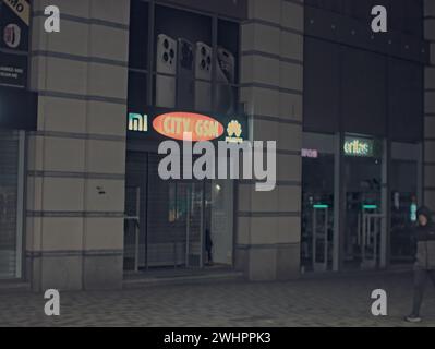 Brussels, Belgium 05-02-2024. Facade of buildings near Roger metro station. City GSM shop. Night logo of Huawei and Xiaomi Stock Photo