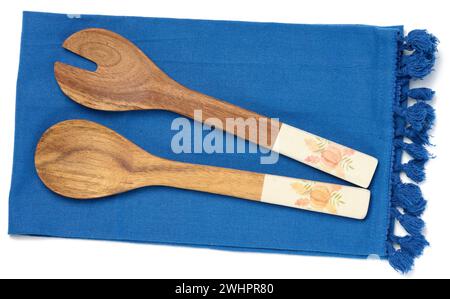 Two wooden spoons on a blue textile kitchen towel, top view Stock Photo