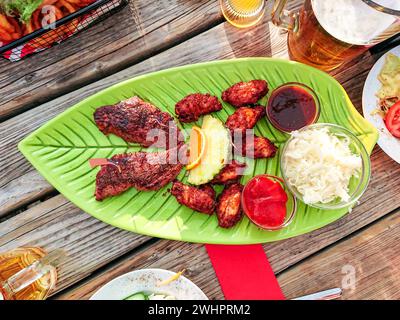 Beef steak with chicken wings and white cabbage salad Stock Photo