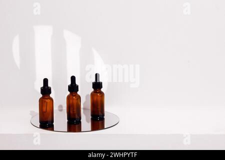 Group of brown bottles and their reflection on a mirror surface Stock Photo