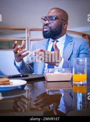 Successful african american businessman executive stylish company leader. Bearded african american man manager millennial in nice suit CEO sitting at Stock Photo