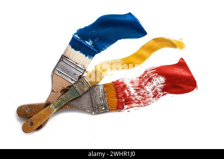Various flat brushes painting blue, yellow and red color on a white background, concept creative business and metaphor for color Stock Photo