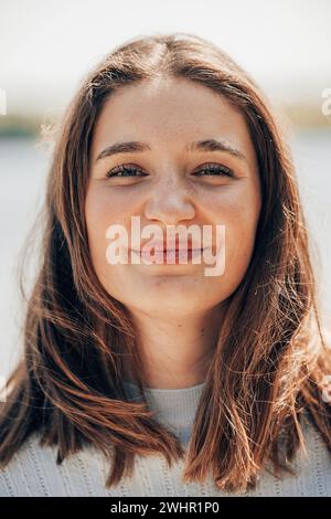 Captivating Millennial Beauty: Brown-Eyed Charmer in Natural Setting Stock Photo