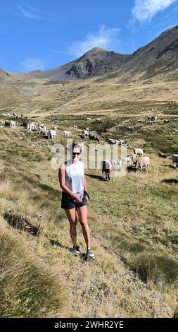 Woman walking with cows in the catalan pyrenees Stock Photo