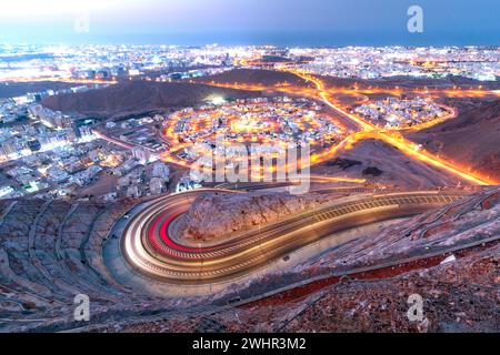 View from Amirat view point on wavy road in Muscat at blue hour time Stock Photo