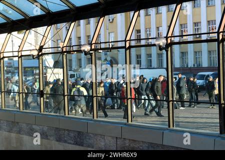 Kyiv. Kyiv region. Ukraine. 10. 20. 2020. People move through the city square, visible through the large glass of the building. Stock Photo