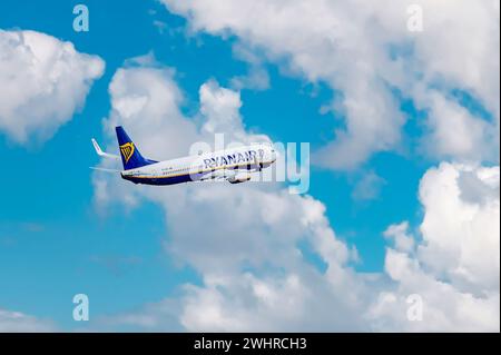 Ryan Air Airline, Airplane in the blue sky with clouds. close up. high flying passenger plane. Stock Photo