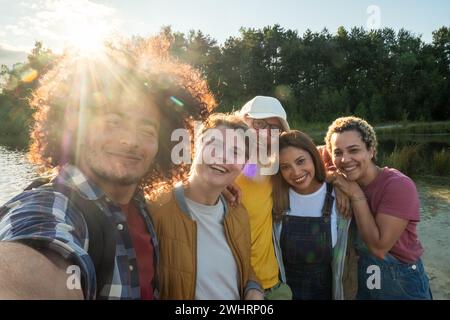 Multiracial young group of trendy people having fun together on vacation - Diverse millennial friends taking selfie portrait tog Stock Photo