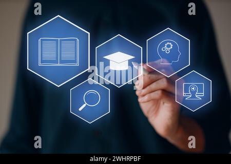 E-learning and Online Education concept. Male student learning internet lesson and pointing pen to device screen icon Stock Photo