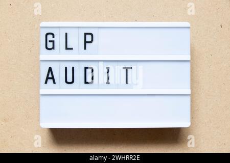Lightbox with word GLP (Abbreviation of Good laboratory practice) audit on wood background Stock Photo