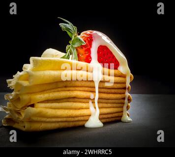 Red strawberry with cream on pancakes stack Stock Photo