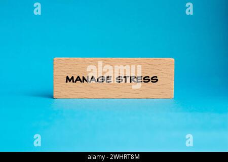 Manage stress lettering on wooden block with blue background. Conceptual mental health photo. Copy space. Stock Photo