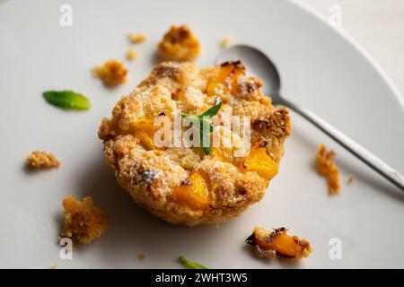 Peach crumble tartlet in a French pastry shop in Paris. Stock Photo