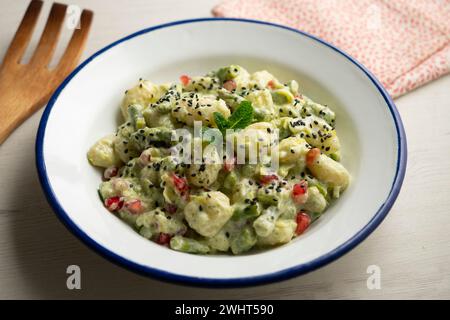 Gnocchi with pesto rosso sauce. Italian potato gnocchi with traditional sauce. Stock Photo
