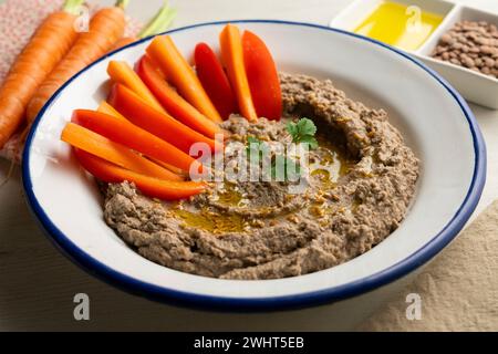 Lentil hummus served with carrot and red pepper. Stock Photo