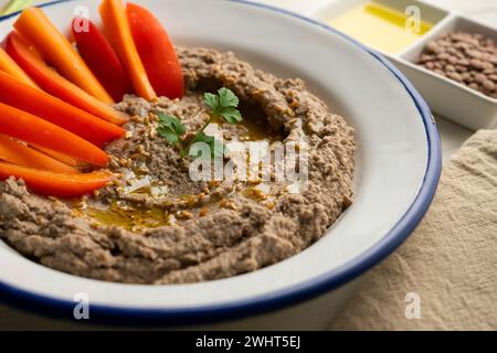 Lentil hummus served with carrot and red pepper. Stock Photo
