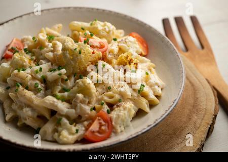 Macaroni cooked with cream, cheese and baked cauliflower. Stock Photo