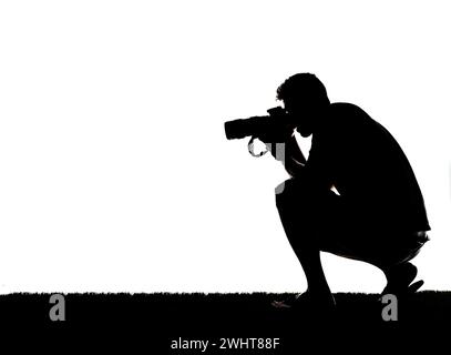 Black and white photograph of a male holding a camera Stock Photo