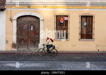 Antigua, Guatemala.  Street Scene, Man Riding Bicycle. Stock Photo