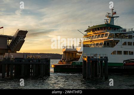 WA25042-00...WASHINGTON - A Washington State passenger and car ferry with a sunset arrival from Clinton at the Mukilteo dock. Stock Photo