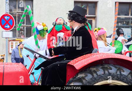 Gaudiwurm carnival parade with a sleeping child on a tractor on Feb 11, 2024 in Marktoberdorf, Germany. Stock Photo