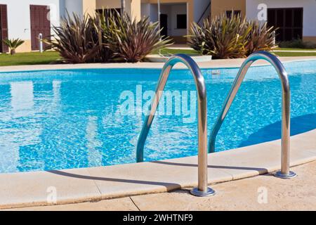 Outdoor Swimming pool with Ladder. Stock Photo
