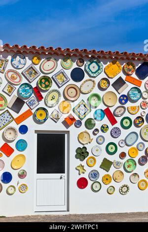 Traditional portuguese pottery plates on a wall in Algarve Stock Photo