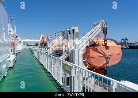 An orange lifeboat raft on a white ferry. High quality photo Stock Photo