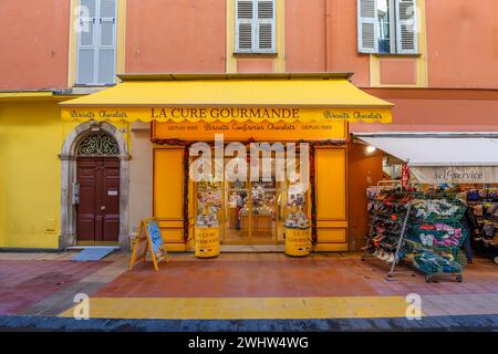 General view of a La Cure Gourmande store, a traditional French biscuit, sweets and Chocolate Artisan bakery, in  historic old town of Menton, France Stock Photo