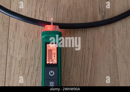 AC voltage detector, instrument for checking electricity in electrical cables without direct contact, the instrument signals the presence of electrici Stock Photo