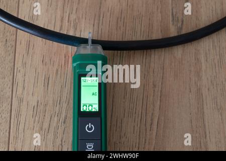 AC voltage detector, instrument for checking electricity in electrical cables without direct contact, the instrument signals the absence of electricit Stock Photo