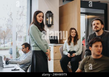Contemporary office space with diverse team engaged in various activities Stock Photo