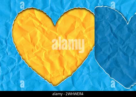 Torn paper in the shape of a heart in the colors of the Ukrainian flag Stock Photo
