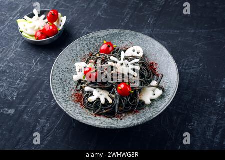 Traditional Halloween octopus spaghetti with Dracula spiders Stock Photo