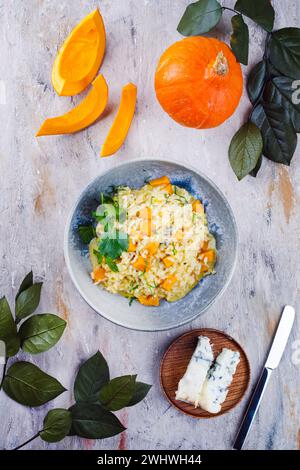 Traditional Italian risotto with Hokkaido pumpkin and gorgonzola soft cheese served as top view in a Nordic design bowl Stock Photo
