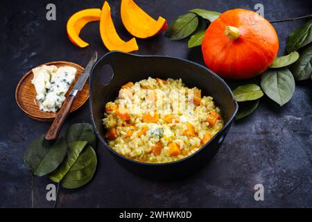 Traditional Italian risotto with Hokkaido pumpkin and gorgonzola soft cheese served as close-up in a Nordic design bowl Stock Photo