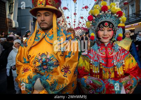 Moscow, Russia. 10th of February, 2024. A Chinese woman and man dressed as a character from the Beijing Opera performs at a street during the Chinese New Year Festival in Moscow in Kamergersky Lane in Moscow, Russia Stock Photo