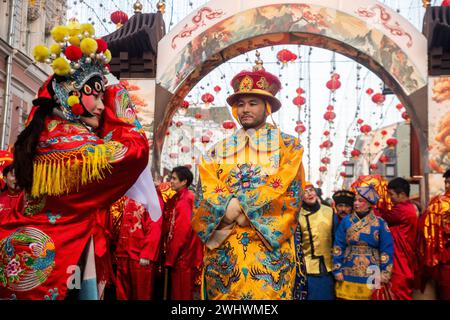 Moscow, Russia. 10th of February, 2024. A Chinese woman and man dressed as a character from the Beijing Opera performs at a street during the Chinese New Year Festival in Moscow in Kamergersky Lane in Moscow, Russia Stock Photo