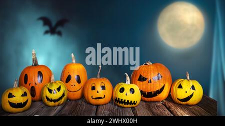 Scary funny Halloween pumpkins on wooden table Stock Photo