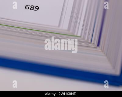 Close-up of the edge of an opened book with the page number and blurry pages and cover Stock Photo