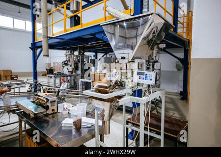 Modern industrial coffee packaging machine. Stock Photo