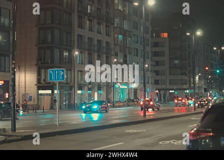 Brussels, Belgium. 5 Feb 2024. Abstract street landscape. Facade of Brussels buildings. City architecture. Night city lights. Cars on the road Stock Photo