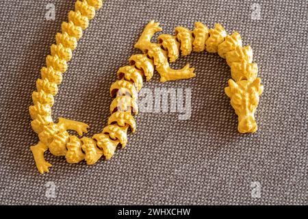 Complex detailed 3D printed dragon snake model, 3d print manufactured bending multi element model printed in one piece, object closeup detail, no peop Stock Photo