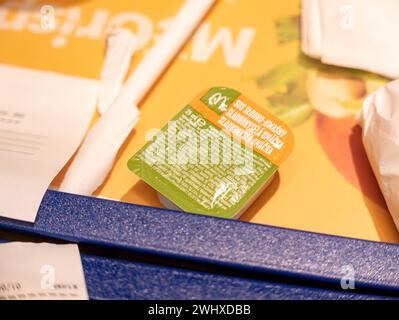 McDonalds sweet and sour sauce 25ml container object macro extreme closeup detail, nobody Ingredients list on box small letters Processed food sauces Stock Photo