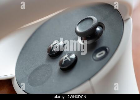 Meta Quest 2 VR headset controller controls object macro, extreme closeup detail. A B and Oculus buttons, analog stick and capacitive surface up close Stock Photo