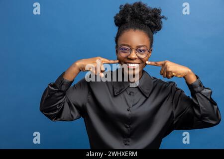 Excited african american woman smiling and looking positive Stock Photo