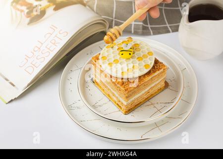 Napoleon cake with honey on a white background Stock Photo