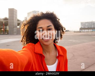 Carefree young African American woman taking a selfie in a city Stock Photo